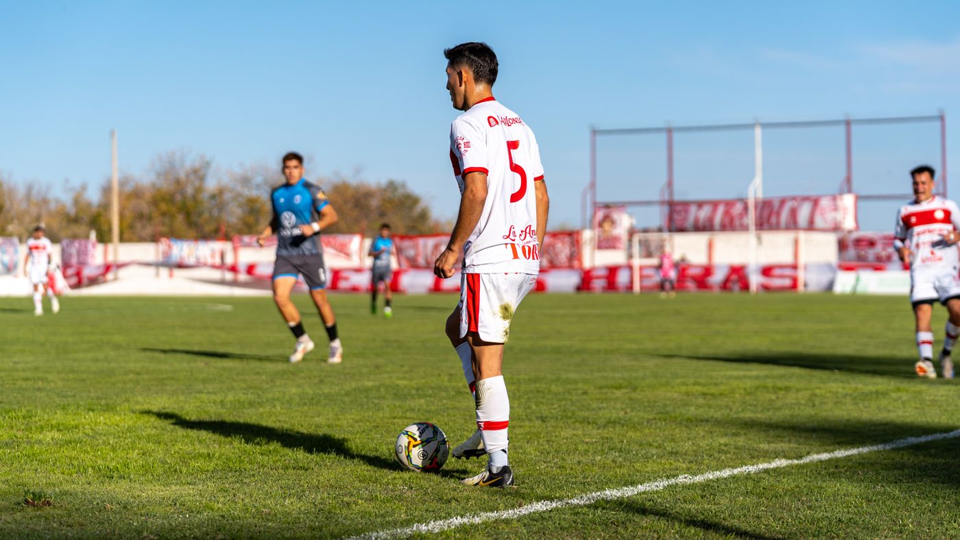 Player standing over the ball preparing to take a free kick