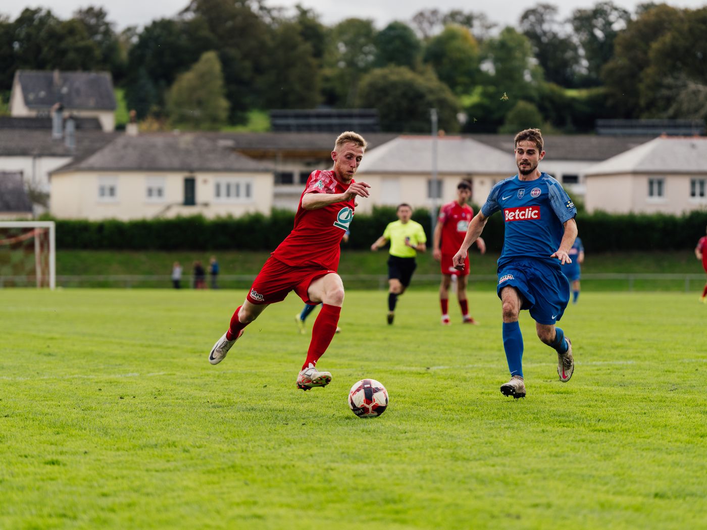 Players competing on a lush green field